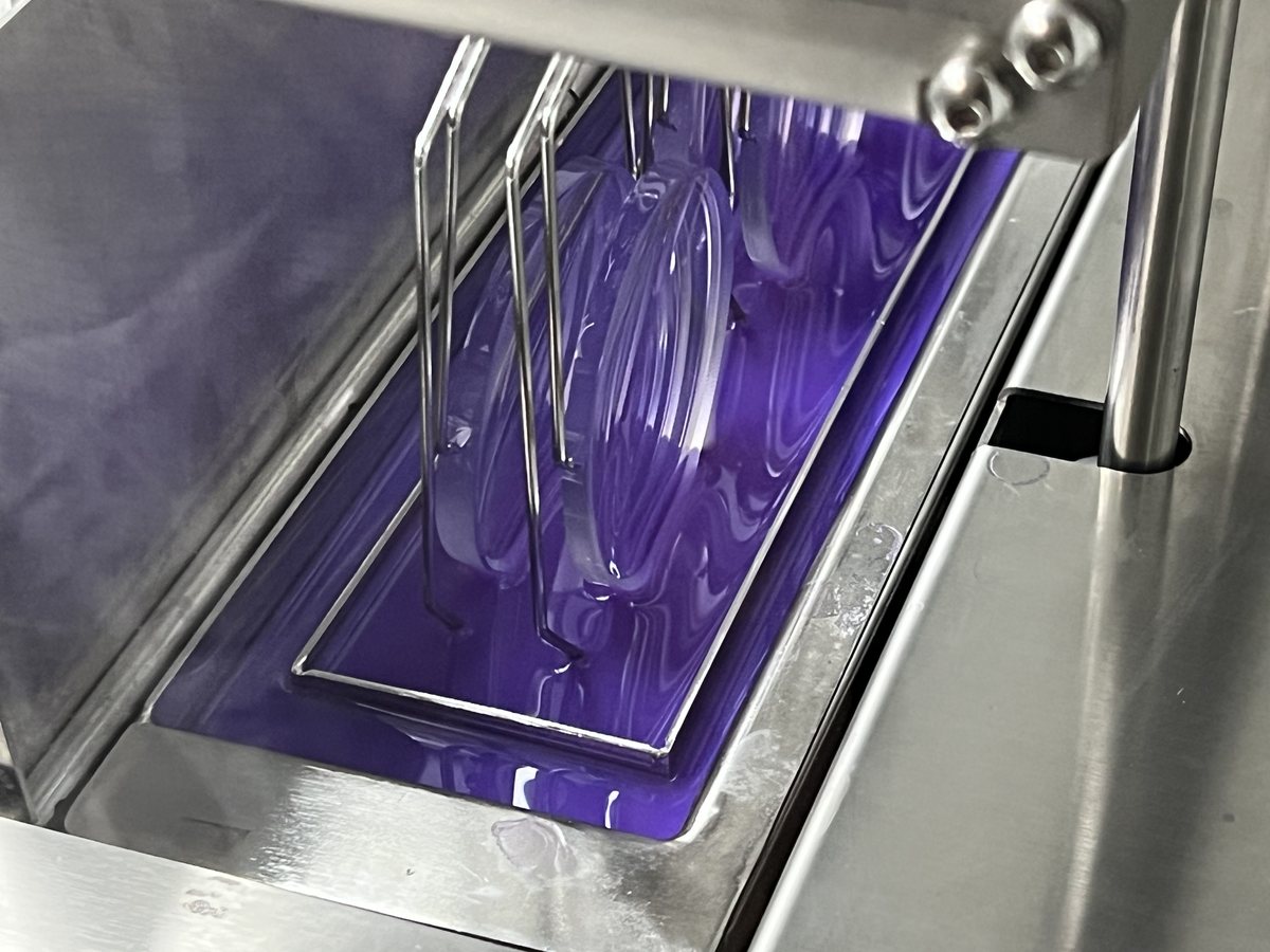 Ophthalmic lenses in a carrier being dip coated inside a Unitech Shyre HC60