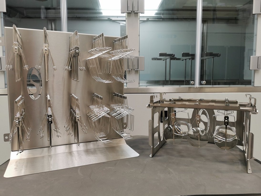 Stainless lens clip rack and loading station tooling